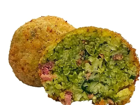 Arancino Cime di Rapa e Salsiccia tagliato a metà, ripieno verde con pezzetti di salsiccia, accanto a un arancino intero